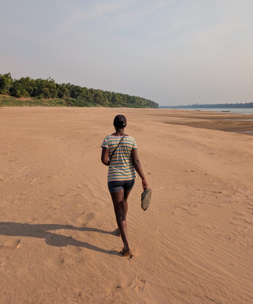 Mary-Ann walking along a huge sandy beach on the Mekong in Kratie.