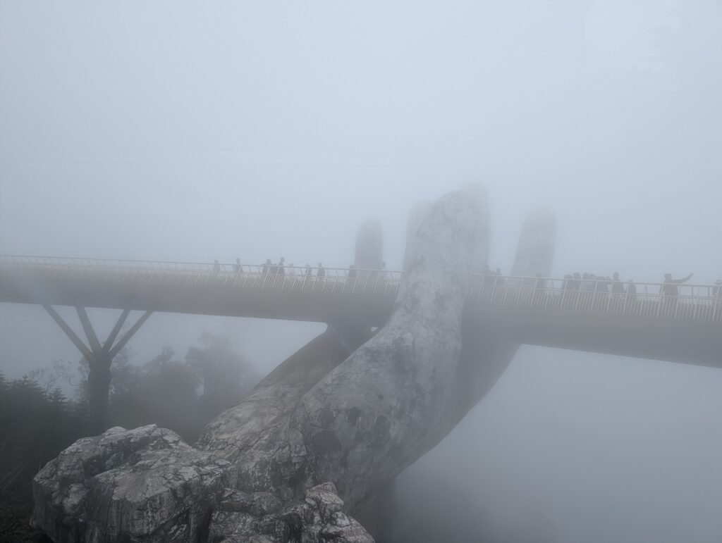 The golden hand bridge in thick fog.