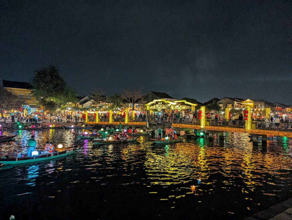 Hoi An river, lit up in hundreds of lights and full or people and boats.