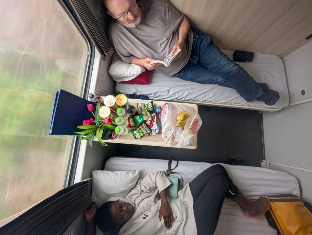 My Dad and Mary-Ann on their beds in the sleeper train cabin.
