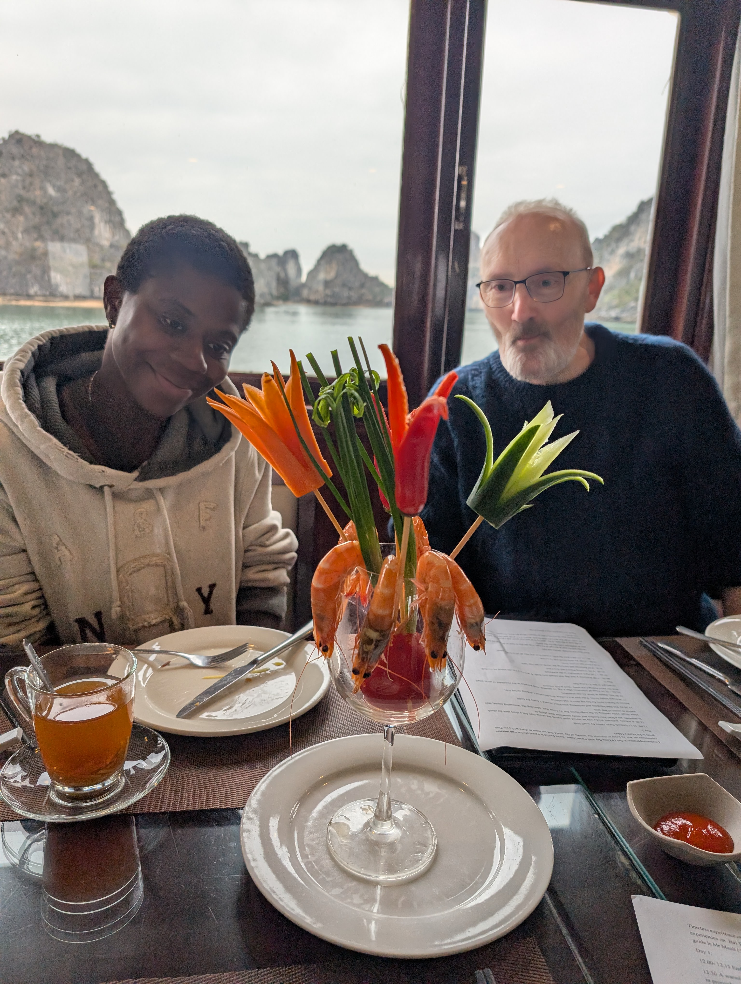 Mary-Ann and my Dad looking lovingly at a prawn dish at the table on the cruise boat.