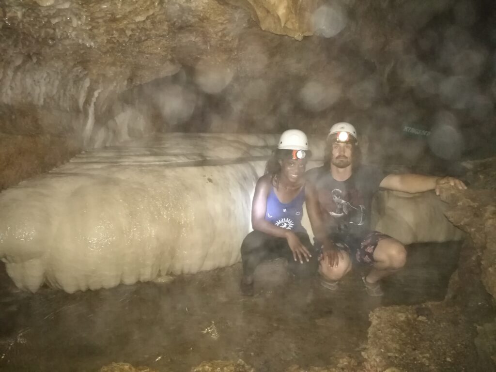 A young Mary-Ann and I crouched in a case infront of a rather impressive chunk of calcite-flow stone.