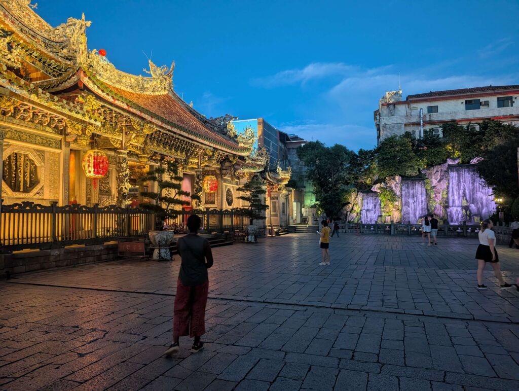 Mary-Ann looking at a temple in dusky Taipei.