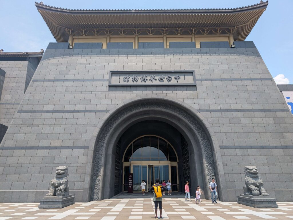 Mary-Ann standing infront of the Chung Tai Chan monastery, looking very small.