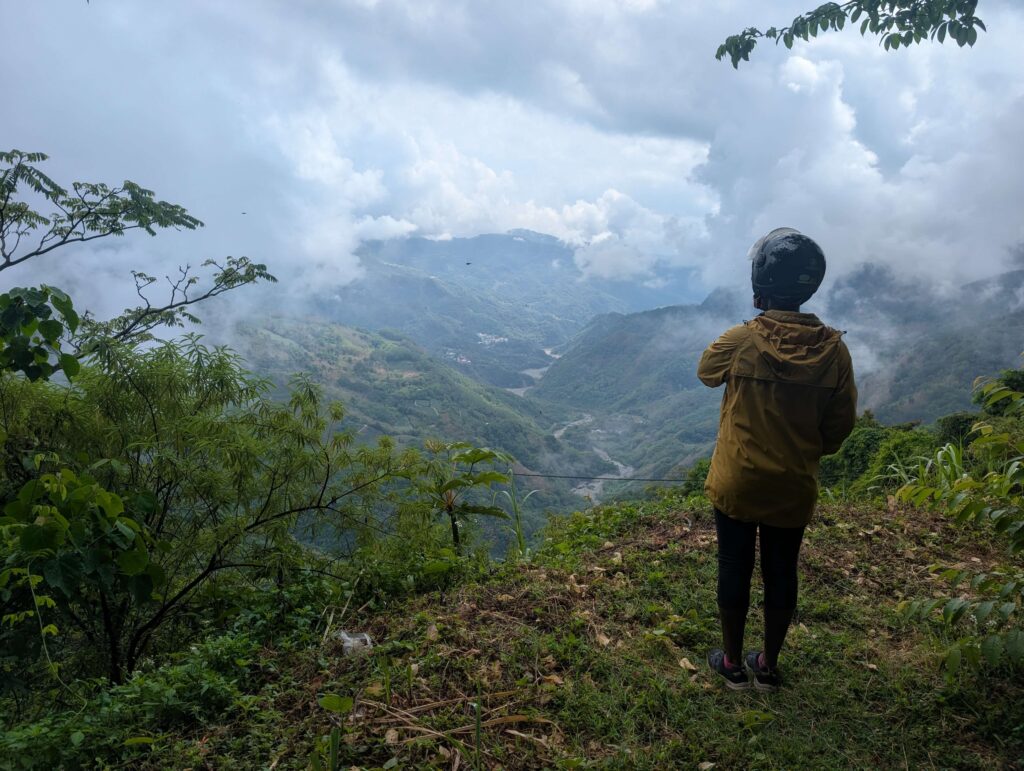 Mary-Ann stood on the edge of a mountain, looking out over an incredible valley.