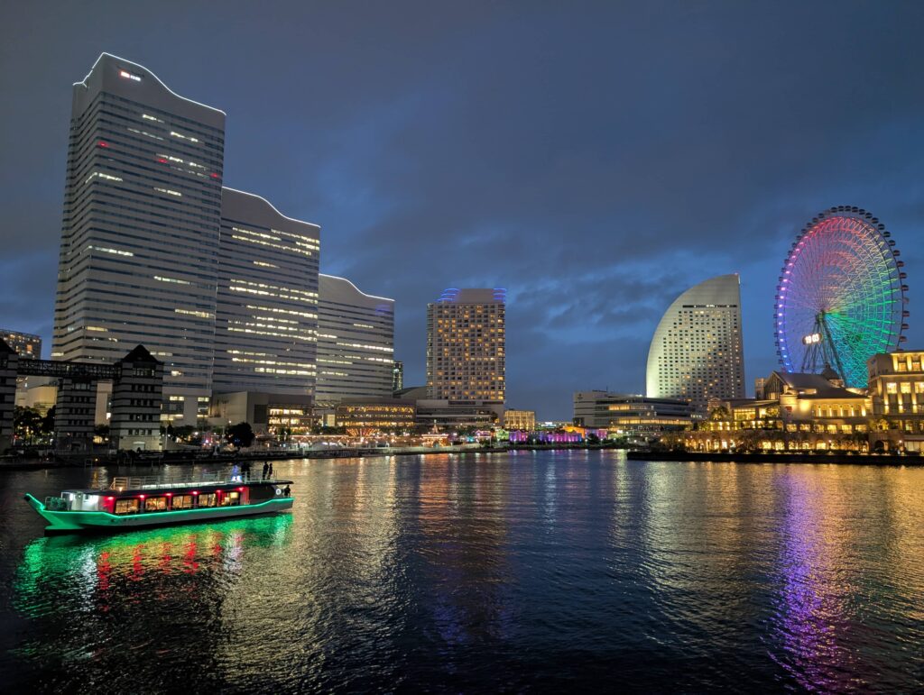 An image across the harbour in Yokohama, showing all the lights and the ferris-wheel.