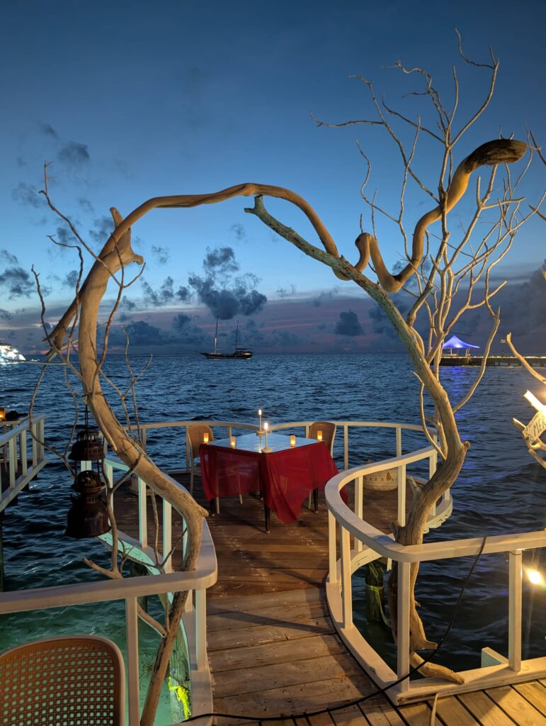 An image of a table at a beach front restaurant, it looks very instagram-worthy.