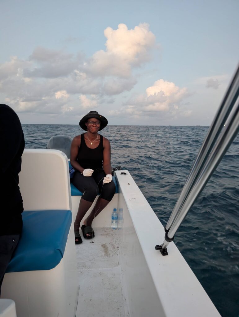 Mary-Ann sitting in the back of a small speed boat.