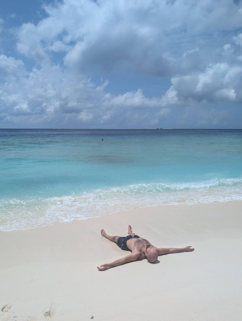 Me laying on the beach like a starfish.