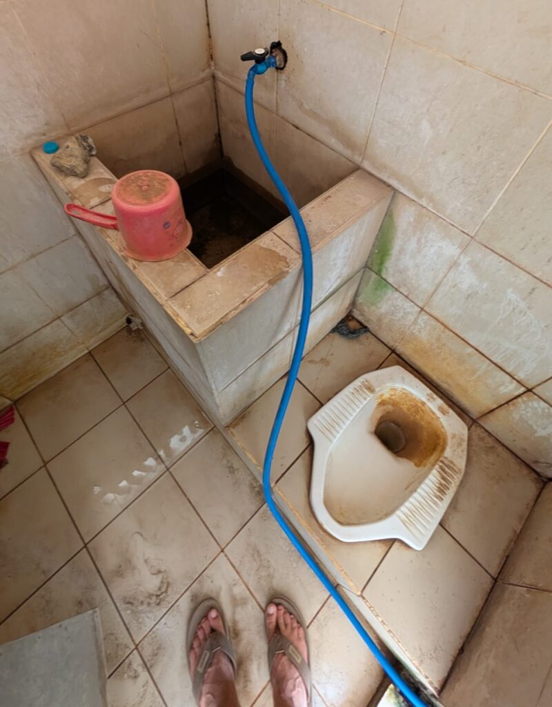 A picture of a rather gross looking squatter toilet somewhere in Indonesia.