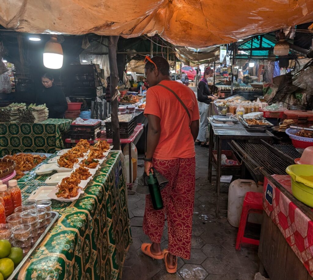 Mary-Ann walking through a local nightmarket somewhere in Cambodia.
