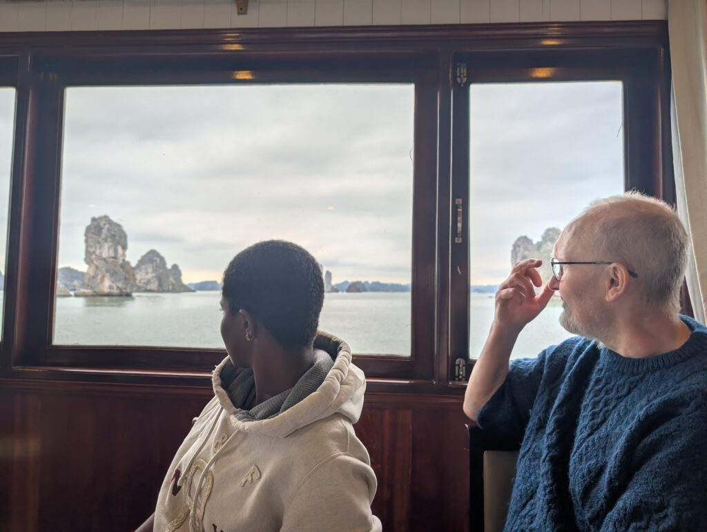 Mary-Ann and my dad looking at Ha-Long bay through the window of the tour boat.