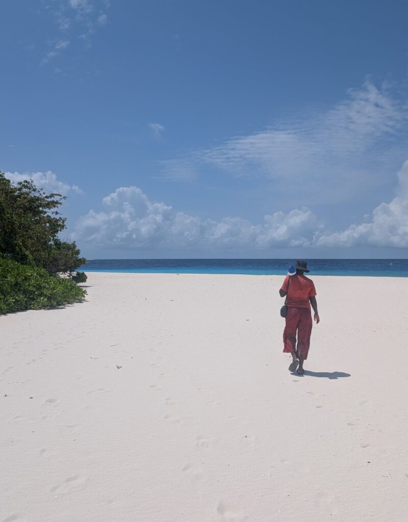 Mary-Ann walking on a perfect white sand beach.